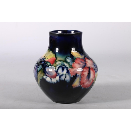 446 - William Moorcroft pottery squat vase, having underglaze bright colour painted and stylised floral de... 