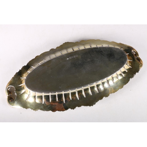 76 - George III gilt silver oval dish with twin handles, chased cast scroll and shell border with two fam... 