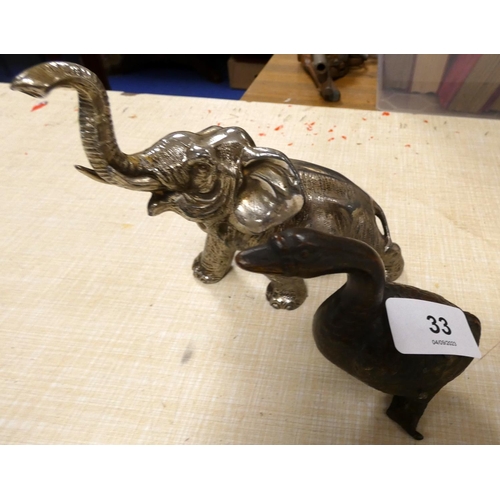 33 - White metal elephant and bronze duck.