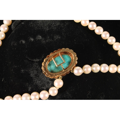 117 - Double strand of pearls choker necklace with yellow metal clasp set with turquoise cabochon surround... 