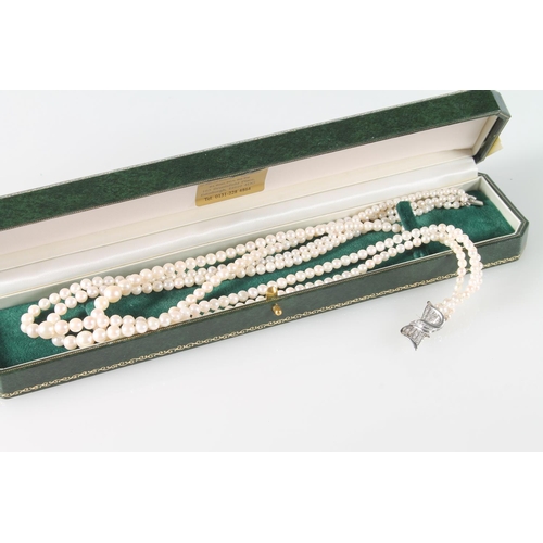 130 - Three strand cultured pearl necklace with 18ct white gold stylized box clasp with chip diamonds, 45c... 