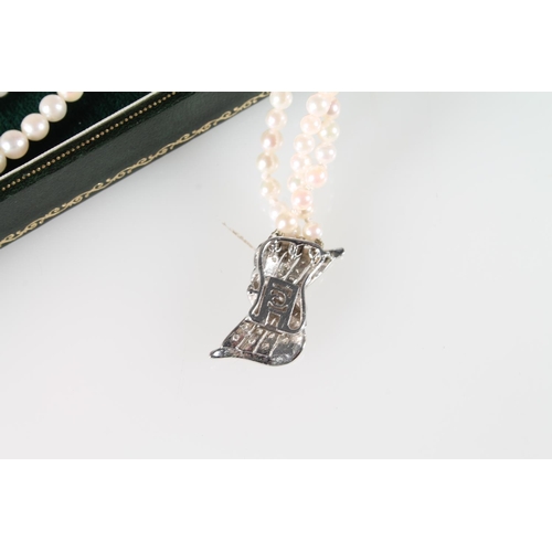 130 - Three strand cultured pearl necklace with 18ct white gold stylized box clasp with chip diamonds, 45c... 