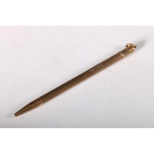 237 - 9ct gold pencil with engine turned exterior and inscription, 9cm, 7.2g. 