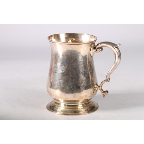 79 - George II silver baluster mug, with a capped scrolled handle, on socle base, hallmarked London 1757,... 