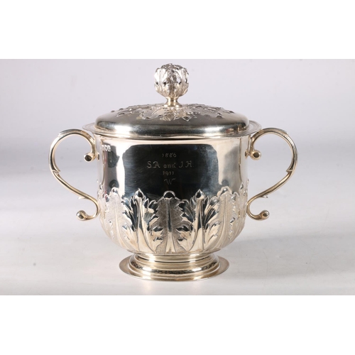 80 - An Edwardian silver twin handled cup and cover having an acanthus decorated knop, the cover similarl... 