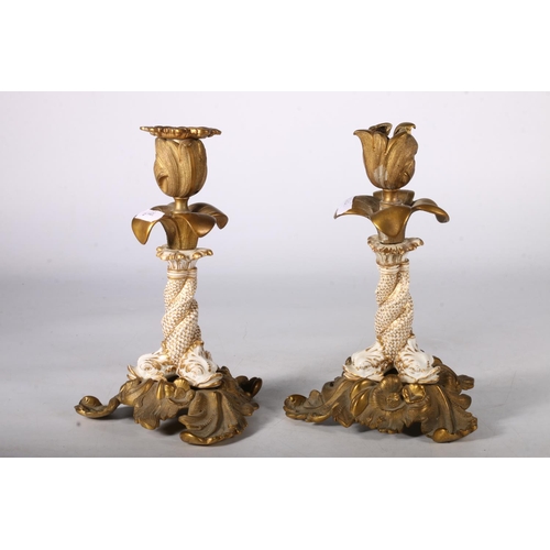 369 - Pair of brass and ceramic flower head candlesticks with Koi fish decorated to the stem, 21cm tall.