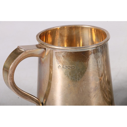 33 - Silver tankard of tapering form, hallmarked Nayler Brothers, London 1947, 9cm, 253g, and a white met... 