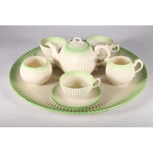 439 - Belleek porcelain cabaret set for three settings, comprising of globular tea pot with cover, three c... 