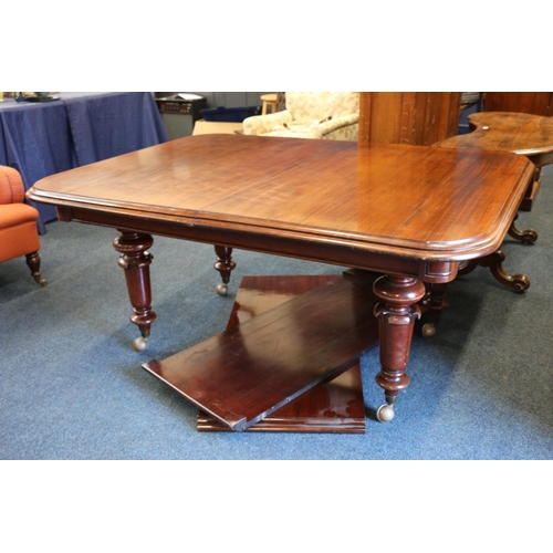 543 - 19th century mahogany telescopic dining table, raised on four turned baluster supports capped by cas... 