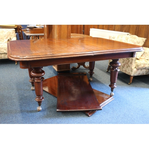 543 - 19th century mahogany telescopic dining table, raised on four turned baluster supports capped by cas... 