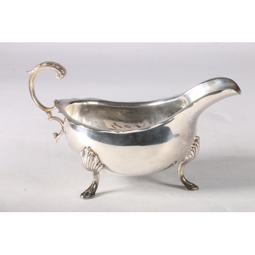 40A - Silver sauceboat with scrolled handle and shell knees on cabriole supports, hallmarked Toye, Kenning... 