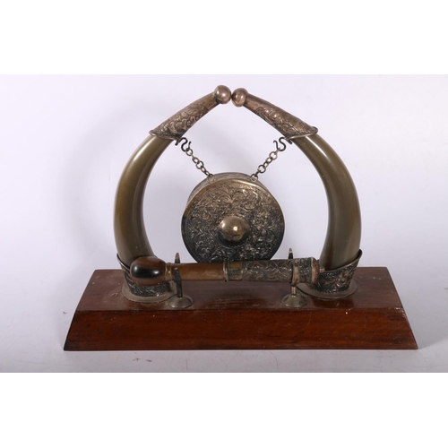 399 - White metal mounted and horn table gong on mahogany base, 22cm. 