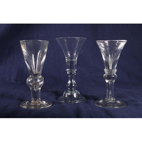 418 - Two 18th Century deceptive glasses with restricted conical bowls and baluster knops on folding feet,... 