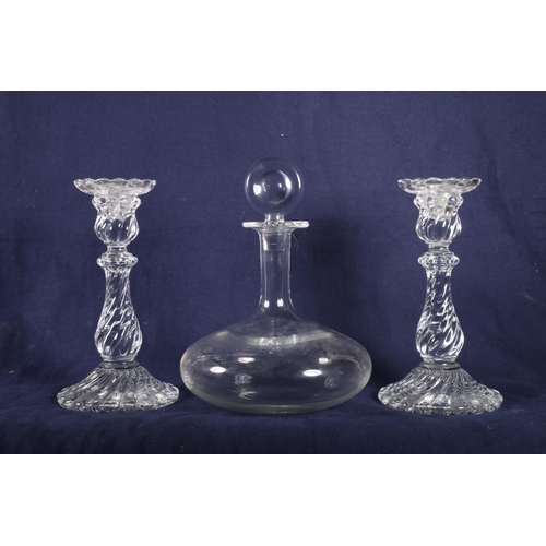 425 - Baccarat ships decanter and two twist style baluster shaped candlesticks, 23cm.