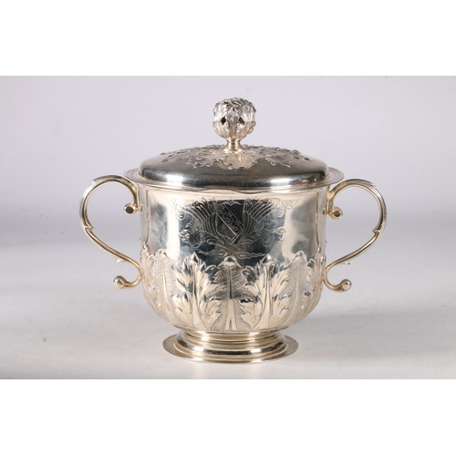 80 - An Edwardian silver twin handled cup and cover having an acanthus decorated knop, the cover similarl... 