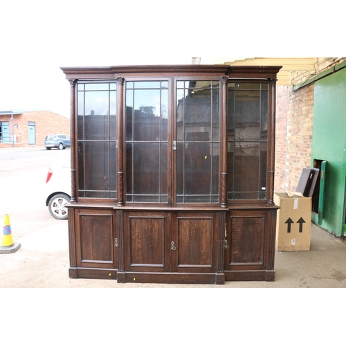 554 - Antique oak breakfront library bookcase, the cornice with moulded edge above four astragal glazed do... 