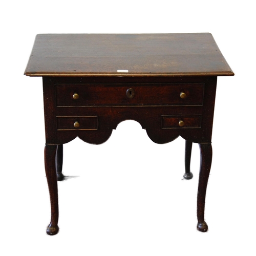 340 - George III oak lowboy with a long drawer above two short drawers and a shaped apron, on cabriole leg... 