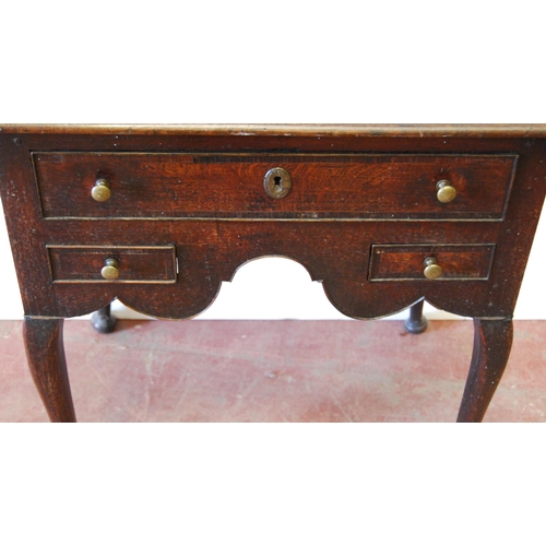 340 - George III oak lowboy with a long drawer above two short drawers and a shaped apron, on cabriole leg... 