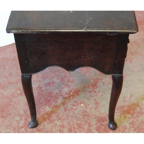 340 - George III oak lowboy with a long drawer above two short drawers and a shaped apron, on cabriole leg... 