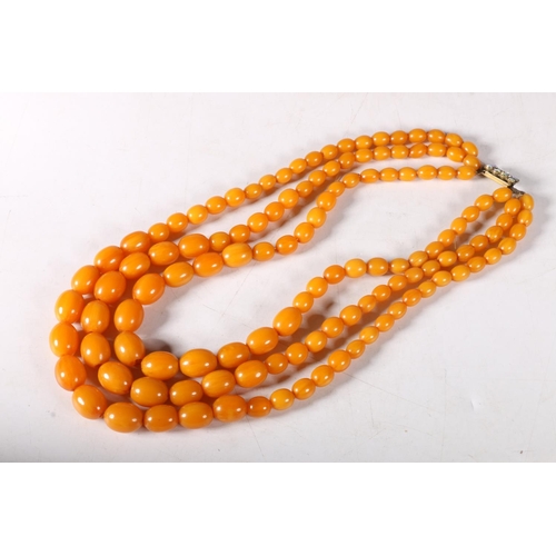 231 - Triple strand of graduated butterscotch amber bead necklace, 24cm, 108g gross.