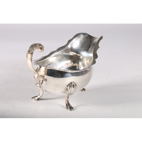 40A - Silver sauceboat with scrolled handle and shell knees on cabriole supports, hallmarked Toye, Kenning... 