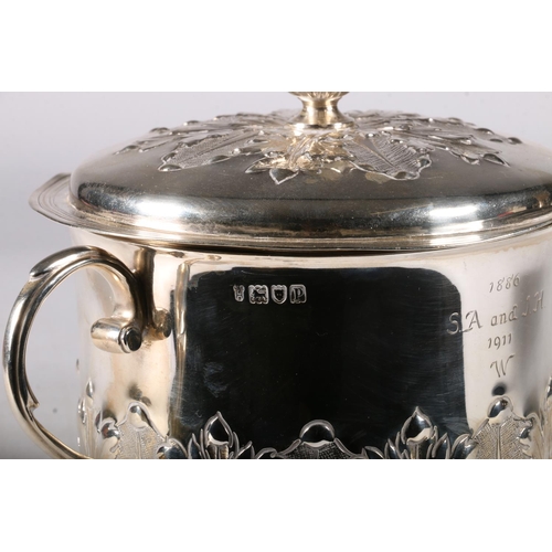 80 - An Edwardian silver twin handled cup and cover having an acanthus decorated knop, the cover similarl... 