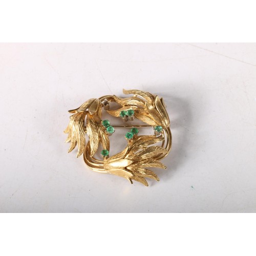 216 - 18ct gold floral brooch with eight green stones, 16.8g, 4cm diameter. 