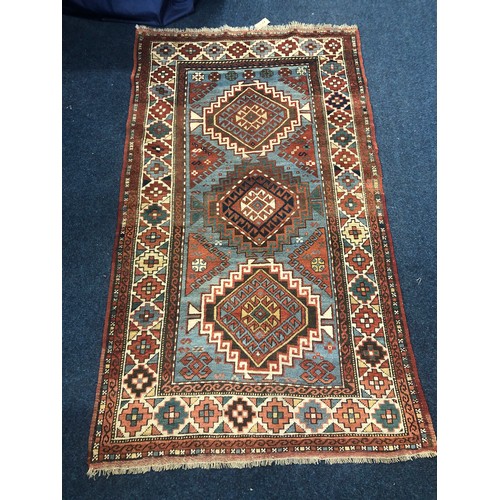 563 - Caucasian rug with three medallions on light blue field within multiple borders, 202 x 117cm.