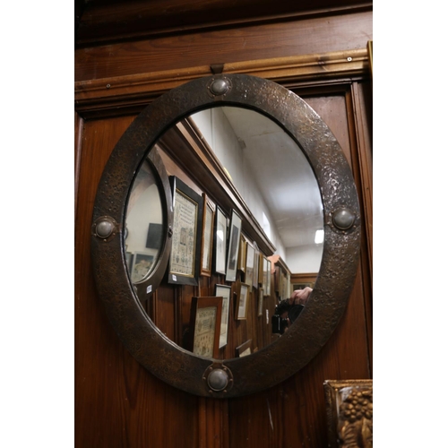 571 - Arts and Crafts oval wall mirror, metal frame with Ruskin roundels, 64 x 54cm.