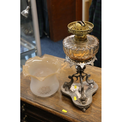 390 - Duplex oil lamp circa early 20th century with later glass shade above glass reservoir and repousse d... 