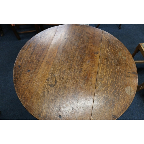 50A - English Oak metamorphic Monks chair with rectangular seat and circular table on carved and turned su... 