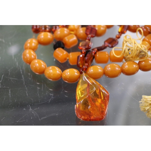 225 - Strand of faux butterscotch amber beads, an amber pendant on necklace, raw amber, earrings, etc.