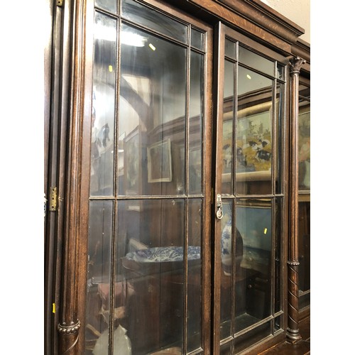 554 - Antique oak breakfront library bookcase, the cornice with moulded edge above four astragal glazed do... 