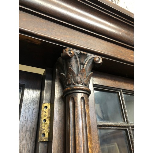 554 - Antique oak breakfront library bookcase, the cornice with moulded edge above four astragal glazed do... 