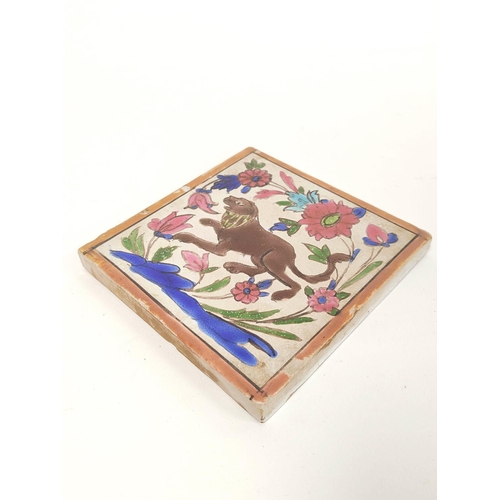 292 - Antique Persian pottery tile decorated with polychrome subject of a lion amongst foliage & flowe... 