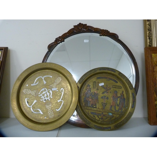 104 - Two circular wall mirrors and a pair of brass Egyptian wall plaques.