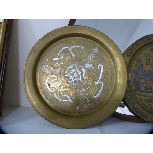 104 - Two circular wall mirrors and a pair of brass Egyptian wall plaques.