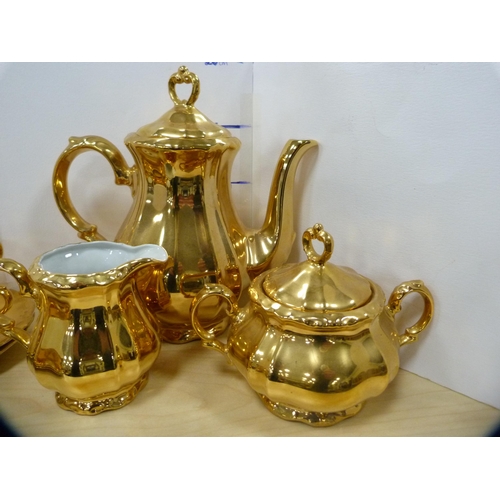 12 - Pair of graduated floral decorated jugs and a Bavarian gilt coffee service.