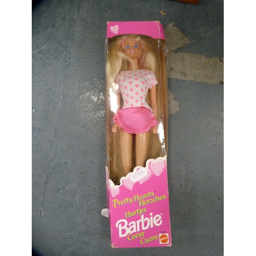 122 - Barbie doll, boxed, and various other figures.