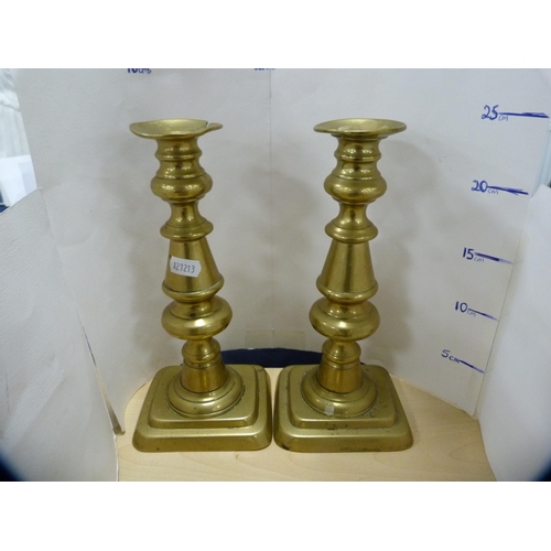 133 - Brass bell and a pair of brass candlesticks.