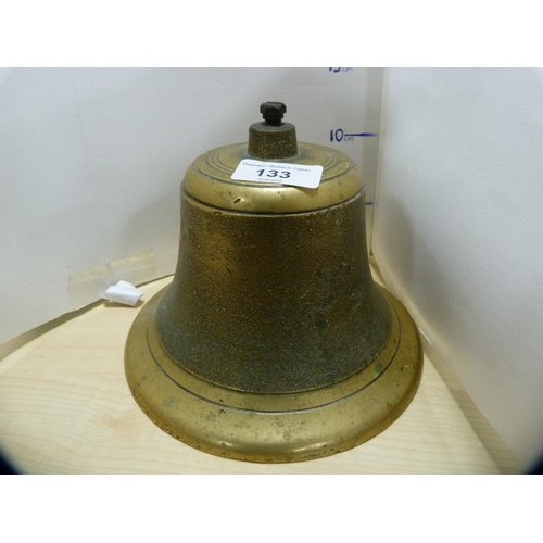 133 - Brass bell and a pair of brass candlesticks.