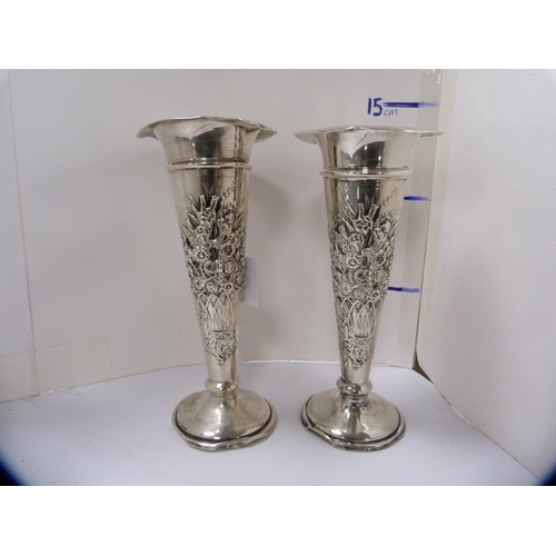 140 - Pair of silver rose vases embossed with baskets of flowers.  (2)