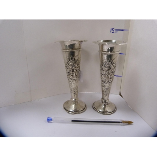 140 - Pair of silver rose vases embossed with baskets of flowers.  (2)