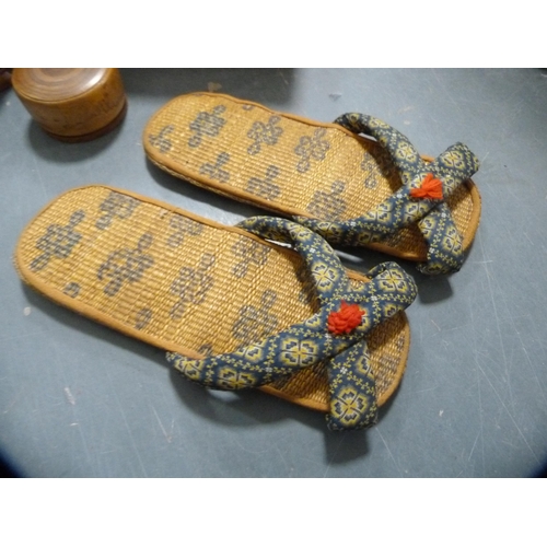 144 - Carton containing collectables to include a pair of Japanese woven slippers, sandalwood fan, Russian... 