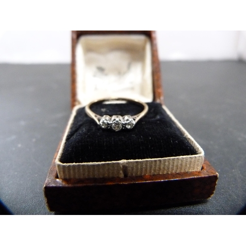 148 - 9ct gold diamond lady's three-stone ring set with three small brilliants, 1.4g gross.