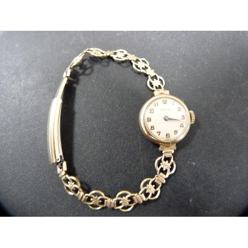 149A - Lady's Griffon wristwatch, possibly 9ct gold backed, on flexible rolled gold bracelet strap.