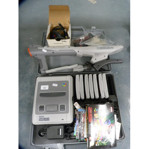 180 - Super Nintendo console, Super NES scope, assorted games and accessories, with carry case.