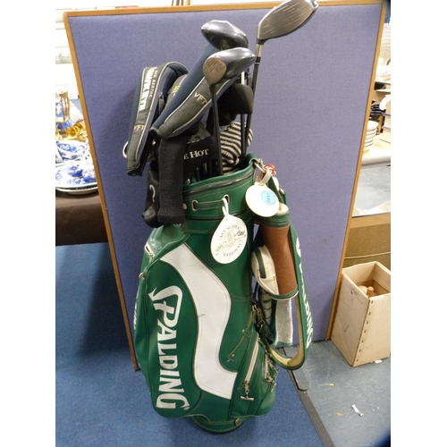 305 - Spalding golf bag containing various clubs to include VFT Hawk Eye, Odyssey White Hot putter etc.