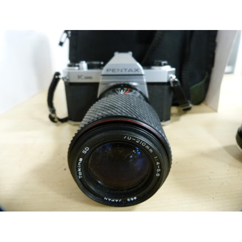 313 - Pentax K1000 camera with Tokina 70-210mm lens, Asahi Pentax ME camera with 35-70mm lens, and a Prakt... 