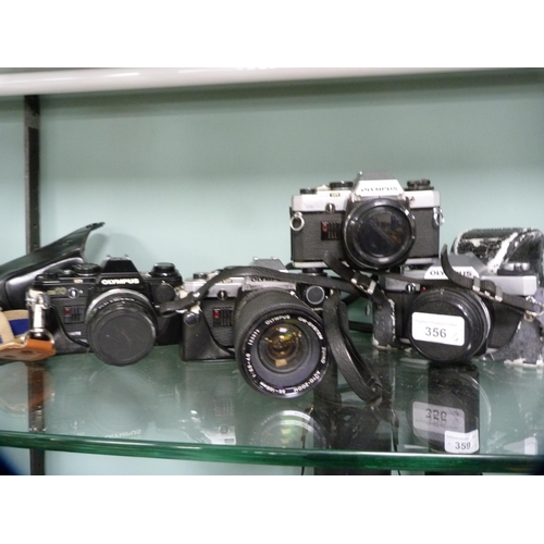 356 - Three Olympus OM10 cameras, one example with an Olympus Zoom 35-150mm lens, and an Olympus OM20 came... 